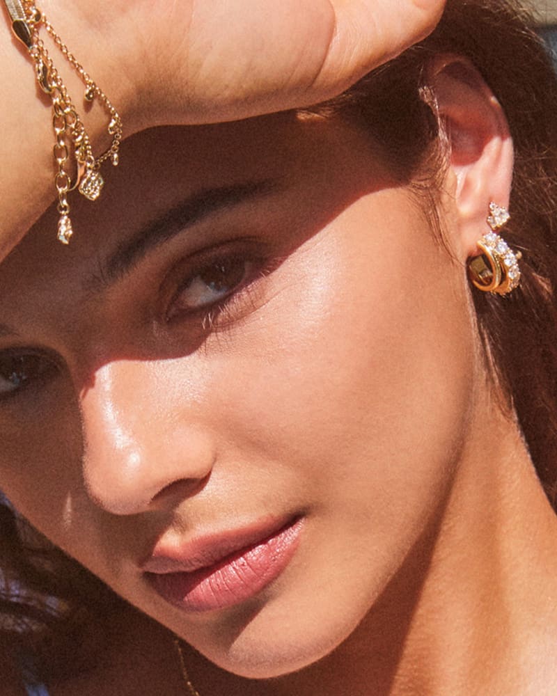 Livy Gold Huggie Earrings In White Crystal
