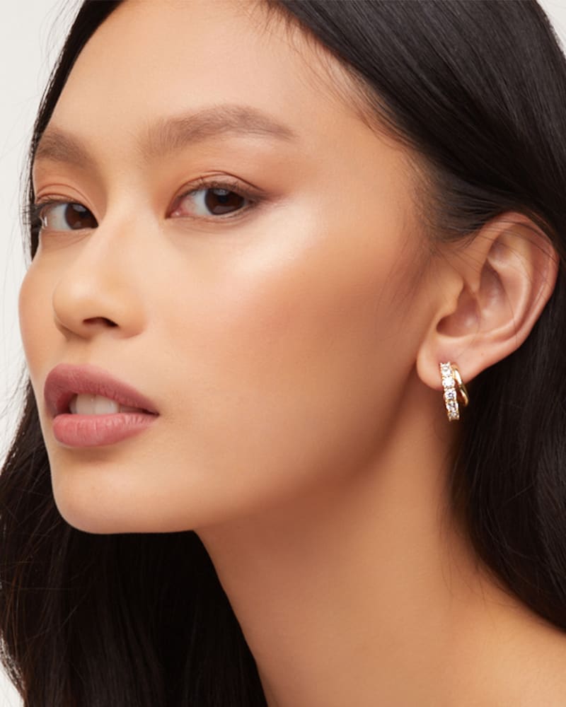 Livy Gold Huggie Earrings In White Crystal